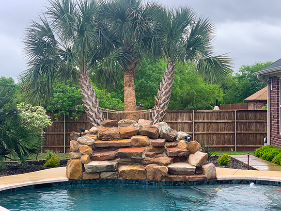 custom waterfall provided by Pool Builder, Pool Installation, Pool Remodel, and Outdoor Kitchen in Cedar Hill, TX